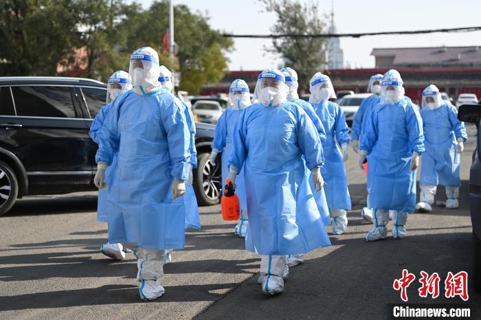 圖為醫(yī)務(wù)人員在封閉小區(qū)做防控工作。　劉文華 攝