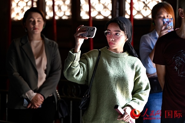 選手顏青（蘇丹）用手機(jī)記錄所見所感。人民網(wǎng) 盧鵬宇攝