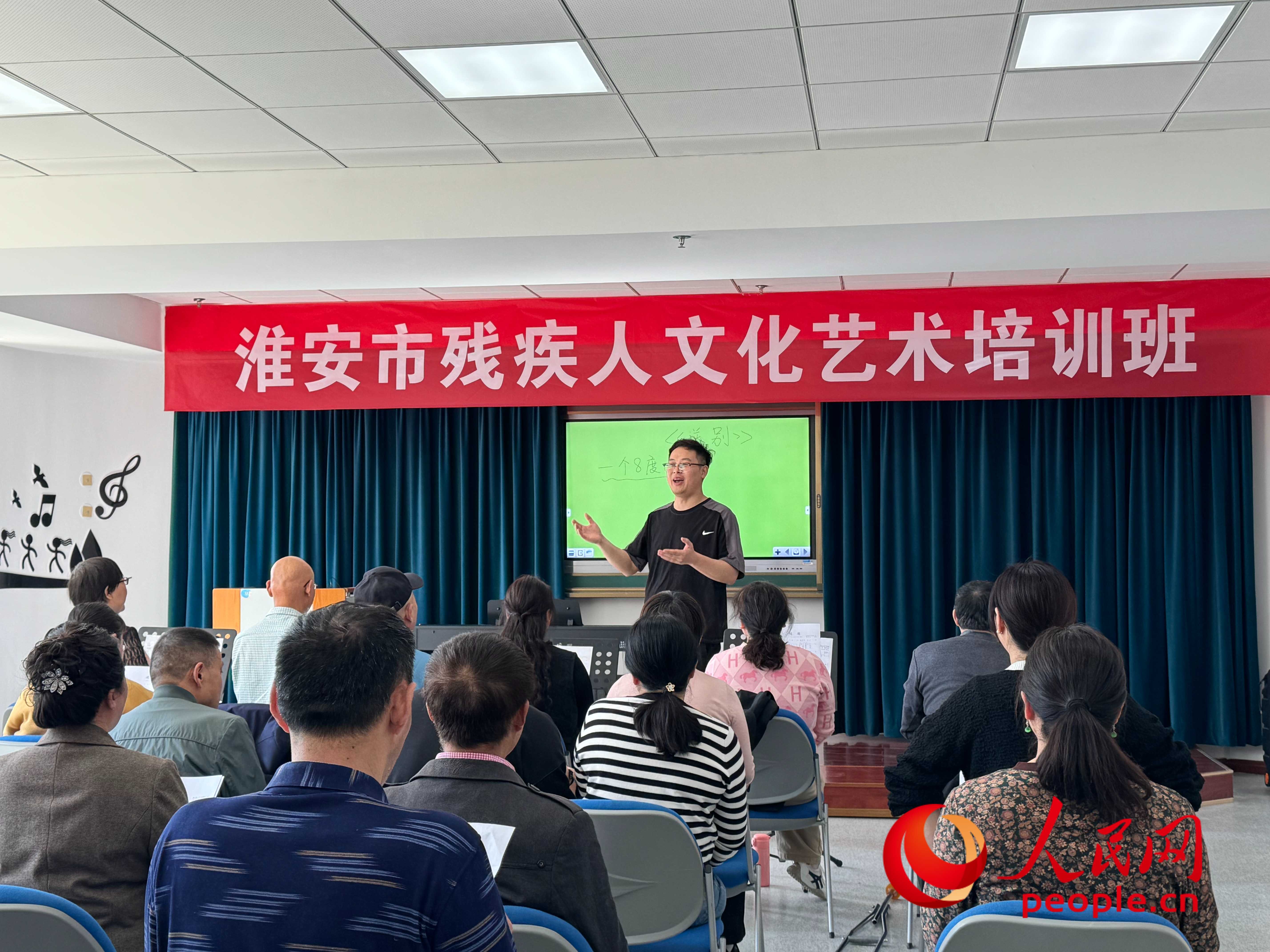 在淮安市殘疾人文化藝術(shù)培訓(xùn)班上，聲樂老師在教殘疾人唱《送別》這首歌曲。人民網(wǎng) 周靜圓攝