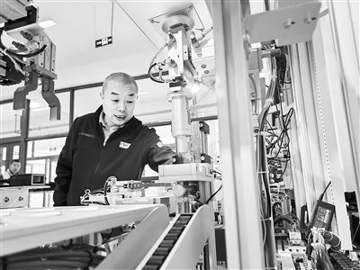 郭海青在檢查車床加工設(shè)備。 受訪者供圖